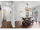 Bright dining room with a modern chandelier and access to the kitchen at 303 Valley Green Ct, Woodstock, GA 30189