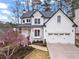 Charming two-story home with a two-car garage and a lovely magnolia tree in the front yard at 303 Valley Green Ct, Woodstock, GA 30189