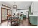 Eat-in kitchen with updated cabinets and countertops, modern lighting, and stainless appliances at 303 Valley Green Ct, Woodstock, GA 30189