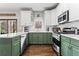 Updated kitchen with stainless steel appliances, white countertops, and modern green cabinets at 303 Valley Green Ct, Woodstock, GA 30189