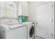 Bright laundry room with modern washer and dryer at 303 Valley Green Ct, Woodstock, GA 30189
