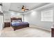 Spacious main bedroom featuring tray ceilings, ceiling fan, and large windows at 303 Valley Green Ct, Woodstock, GA 30189