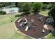 Community playground with multiple slides and climbing structures, covered picnic area, and seating surrounded by green space at 303 Valley Green Ct, Woodstock, GA 30189