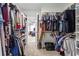 Spacious walk-in closet with ample shelving and storage space for clothes and accessories at 303 Valley Green Ct, Woodstock, GA 30189