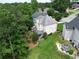 Aerial view of a home with lush green lawn, landscaped yard, and a fire pit at 335 Lake Bluff Ct, Suwanee, GA 30024