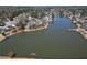 Aerial view of a lake community with homes situated around a large lake at 335 Lake Bluff Ct, Suwanee, GA 30024