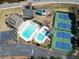 Aerial view of community pool, playground, tennis courts, and a parking lot at 335 Lake Bluff Ct, Suwanee, GA 30024