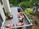 Elevated view of back deck featuring stylish patio furniture and lake views at 335 Lake Bluff Ct, Suwanee, GA 30024