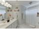 Bright bathroom with double vanity, framed mirror, and shower with curtain at 335 Lake Bluff Ct, Suwanee, GA 30024