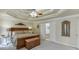 Bedroom suite featuring a tray ceiling, sitting area, and neutral decor at 335 Lake Bluff Ct, Suwanee, GA 30024