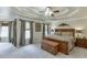 Spacious bedroom with a tray ceiling, sitting area, and neutral decor at 335 Lake Bluff Ct, Suwanee, GA 30024