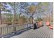 Back deck overlooking a lake with chairs, a grill, and scenic views at 335 Lake Bluff Ct, Suwanee, GA 30024