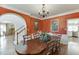 Formal dining room featuring a large wooden table, chandelier, wainscoting, and access to the living room at 335 Lake Bluff Ct, Suwanee, GA 30024
