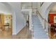 Elegant two-story entryway with hardwood floors, staircase, and arched doorways leading to other rooms at 335 Lake Bluff Ct, Suwanee, GA 30024