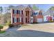 Front exterior of a two-story brick home with well-manicured lawn at 335 Lake Bluff Ct, Suwanee, GA 30024