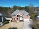 Beautiful two-story brick home with a well-maintained lawn and landscaping, near a lake at 335 Lake Bluff Ct, Suwanee, GA 30024