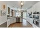 Spacious kitchen featuring stone countertops, stainless steel appliances, and hardwood floors at 335 Lake Bluff Ct, Suwanee, GA 30024