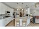 Bright white kitchen featuring granite countertops, stainless steel appliances, and hardwood floors at 335 Lake Bluff Ct, Suwanee, GA 30024