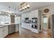 Well-equipped kitchen featuring white cabinets, granite countertops, stainless steel appliances, and hardwood floors at 335 Lake Bluff Ct, Suwanee, GA 30024