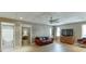 Basement living room features plank flooring, TV, and transitional decor at 335 Lake Bluff Ct, Suwanee, GA 30024