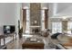 Bright and airy living room with a stone fireplace, two-story windows, and hardwood floors at 335 Lake Bluff Ct, Suwanee, GA 30024