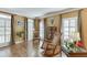 Cozy living room with hardwood floors, large windows, plantation shutters, and comfortable seating at 335 Lake Bluff Ct, Suwanee, GA 30024