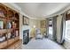 Sitting room featuring a fireplace, built-in shelving, and natural light at 335 Lake Bluff Ct, Suwanee, GA 30024