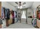 Spacious walk-in closet with carpeted floor, natural lighting, and plentiful storage at 335 Lake Bluff Ct, Suwanee, GA 30024