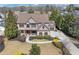 Expansive aerial view showcasing a home with lush landscaping, a long driveway, and a basketball hoop by the garage at 4020 Toulon Ln, Cumming, GA 30040