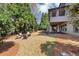 Large backyard with mature trees, patio seating, and view of the house at 4020 Toulon Ln, Cumming, GA 30040
