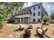 Backyard featuring an open-air porch, fire pit and comfortable seating, creating an inviting outdoor living space at 4020 Toulon Ln, Cumming, GA 30040