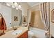Bathroom with framed mirror, traditional fixtures, tub and shower combo, and neutral colors at 4020 Toulon Ln, Cumming, GA 30040