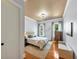 Bedroom features hardwood floors, large windows, a queen sized bed, and light blue walls at 4020 Toulon Ln, Cumming, GA 30040