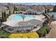 Aerial view of a community pool surrounded by lounge areas, tennis courts, and greenery at 4020 Toulon Ln, Cumming, GA 30040