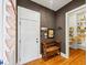 Entryway with hardwood floors, a white door, a storage bench, and a view into the pantry at 4020 Toulon Ln, Cumming, GA 30040