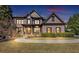 Lovely brick home featuring lush landscaping, walkway to covered front porch and driveway at 4020 Toulon Ln, Cumming, GA 30040