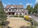 Picturesque two-story home with mature trees, professional landscaping, and a convenient circular driveway for easy access at 4020 Toulon Ln, Cumming, GA 30040