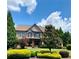 Charming exterior view highlighting the lush lawn and inviting front porch at 4020 Toulon Ln, Cumming, GA 30040