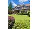 Beautiful brick home boasts a lush lawn and meticulously maintained landscaping at 4020 Toulon Ln, Cumming, GA 30040