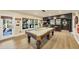 Game room featuring a pool table, built-in bar area, vinyl floors, and ample natural light at 4020 Toulon Ln, Cumming, GA 30040