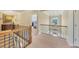 Hallway with staircase, chandelier, artwork, and view into bedroom at 4020 Toulon Ln, Cumming, GA 30040