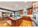 Bright kitchen with an island, stainless steel appliances, and a breakfast table with connecting living room space at 4020 Toulon Ln, Cumming, GA 30040