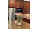 Granite countertop, wooden cabinets and stainless steel refrigerator and microwave at 4020 Toulon Ln, Cumming, GA 30040