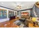 Open-concept living room boasts hardwood floors, a cozy sectional sofa, and seamless access to the kitchen at 4020 Toulon Ln, Cumming, GA 30040