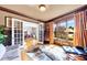 Cozy living room with hardwood floors, large windows, and French doors, providing a bright and inviting space at 4020 Toulon Ln, Cumming, GA 30040