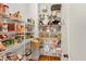 Walk-in pantry with bright white wire shelving filled with food and cookware items at 4020 Toulon Ln, Cumming, GA 30040