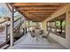 Covered patio with outdoor seating and stairs to backyard at 4020 Toulon Ln, Cumming, GA 30040