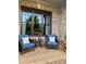 Inviting covered front porch area with comfortable seating and charming details at 4020 Toulon Ln, Cumming, GA 30040