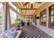 Enclosed sunroom with ceiling fan, wood decking, outdoor views and comfortable furnishings at 4020 Toulon Ln, Cumming, GA 30040