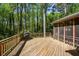 Outdoor deck with wood railings, gas grill and screened-in porch at 4400 Huntington Cir, Dunwoody, GA 30338